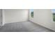 Bright and spacious carpeted bedroom with two windows at 4497 Yaupon Holly Way, Lakeland, FL 33811