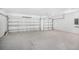 Spacious garage with two doors and concrete floors at 4497 Yaupon Holly Way, Lakeland, FL 33811