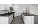 Modern open concept kitchen with stainless steel appliances, granite countertops, and a spacious island at 4497 Yaupon Holly Way, Lakeland, FL 33811
