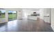 Bright, open-concept living area with tile floors and a modern kitchen featuring a center island and stainless appliances at 4497 Yaupon Holly Way, Lakeland, FL 33811