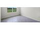 Room with a view of green space through the window; has gray tile floor, and baseboard at 4497 Yaupon Holly Way, Lakeland, FL 33811
