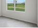 Bright room featuring view of green space and blue sky through large window, with tile floor at 4497 Yaupon Holly Way, Lakeland, FL 33811