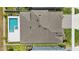 Aerial view of the roof, backyard pool, and surrounding lawn at 4779 Cragmere Loop, Clermont, FL 34711