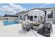 Backyard patio with outdoor furniture, including sofas and lounge chairs by the pool at 4779 Cragmere Loop, Clermont, FL 34711