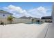 The backyard shows the pool with a white stone patio and a privacy fence at 4779 Cragmere Loop, Clermont, FL 34711