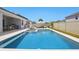 The backyard features a pool with an outdoor kitchen and relaxing patio furniture at 4779 Cragmere Loop, Clermont, FL 34711