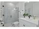 Bathroom featuring a black faucet, a flower vase, white cabinets, and glass shower at 4779 Cragmere Loop, Clermont, FL 34711