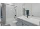 Bright bathroom featuring marble tile, grey vanity, tub and a shower at 4779 Cragmere Loop, Clermont, FL 34711