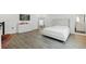 Spacious bedroom featuring wood floors, white walls, and a queen-size bed at 4779 Cragmere Loop, Clermont, FL 34711