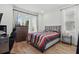 Comfortable bedroom with wood floors, large windows and a cozy queen size bed at 4779 Cragmere Loop, Clermont, FL 34711