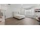 Bright bedroom with a large window, wood floors and a queen-size bed at 4779 Cragmere Loop, Clermont, FL 34711