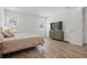 Bright bedroom with wood-look tile flooring and large windows that let in plenty of natural light at 4779 Cragmere Loop, Clermont, FL 34711