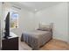 Cozy bedroom with wood floors, a window and a queen size bed at 4779 Cragmere Loop, Clermont, FL 34711