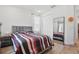 Comfortable bedroom with wood floors, large mirror, and a cozy queen size bed at 4779 Cragmere Loop, Clermont, FL 34711
