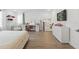 Bright bedroom features a modern vanity, TV and stylish decor at 4779 Cragmere Loop, Clermont, FL 34711