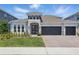 Beautiful two-story home with a three car garage, well-manicured lawn, and stone accents at 4779 Cragmere Loop, Clermont, FL 34711