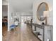 Bright foyer featuring wood-look flooring, modern console table with decor and an attractive round mirror at 4779 Cragmere Loop, Clermont, FL 34711