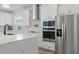 Close up of kitchen featuring stainless steel appliances, custom cabinets, and quartz countertops at 4779 Cragmere Loop, Clermont, FL 34711