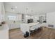 Bright, open kitchen featuring a large island with seating, stainless steel appliances, and modern cabinetry at 4779 Cragmere Loop, Clermont, FL 34711