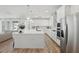 Spacious kitchen with a large quartz island, stainless steel appliances, and wood-look tile flooring at 4779 Cragmere Loop, Clermont, FL 34711