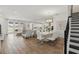 Open-concept living and dining area, featuring elegant flooring, white walls, and staircase to the right at 4779 Cragmere Loop, Clermont, FL 34711