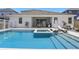 Relaxing backyard pool and patio with a built-in spa and covered outdoor dining area at 4779 Cragmere Loop, Clermont, FL 34711