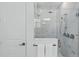 Modern glass enclosed shower with marble tile, rainfall showerhead, and chrome fixtures at 4779 Cragmere Loop, Clermont, FL 34711