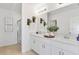 Elegant bathroom with dual sinks, a large mirror, white cabinets, and a glass-enclosed shower at 4928 Bluebell Ct, Lake Hamilton, FL 33851