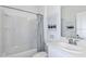 Clean bathroom design featuring a shower-tub combination, modern fixtures and a framed, decorative art print at 4928 Bluebell Ct, Lake Hamilton, FL 33851