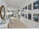 Inviting hallway featuring tile flooring, artwork, and views into the living and dining areas at 4928 Bluebell Ct, Lake Hamilton, FL 33851