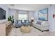 Cozy living room with light blue walls, comfortable seating, stylish decor and plenty of natural light at 4928 Bluebell Ct, Lake Hamilton, FL 33851