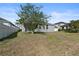 Spacious backyard with a mature tree, and privacy fence at 5108 Creekside Park Ave, Orlando, FL 32811