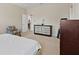 Bright bedroom with neutral tones, carpet, and a sitting chair at 5108 Creekside Park Ave, Orlando, FL 32811