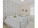 Charming bedroom with detailed wallpaper, a wrought iron bed frame, and a well-lit desk area at 5108 Creekside Park Ave, Orlando, FL 32811