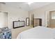 Bright bedroom with a white bed, carpet, and -and- closets on opposite walls at 5108 Creekside Park Ave, Orlando, FL 32811