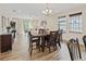 Open concept dining area with wood-look flooring, chandelier, and seamless flow to living space at 5108 Creekside Park Ave, Orlando, FL 32811