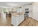 Modern kitchen featuring white cabinetry, stainless steel appliances, and an island with a breakfast bar at 5108 Creekside Park Ave, Orlando, FL 32811