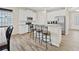 Well-lit kitchen with white cabinets, stainless steel appliances, and barstool seating at the island at 5108 Creekside Park Ave, Orlando, FL 32811