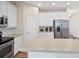 Well-equipped kitchen featuring white cabinetry, stainless steel appliances, and a breakfast bar area at 5108 Creekside Park Ave, Orlando, FL 32811