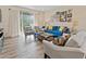 Well-lit living room showcasing wood floors, stylish furniture, and a sliding glass door leading to the backyard at 5108 Creekside Park Ave, Orlando, FL 32811