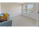 Bright room with natural light, a blue sofa, wainscoting, and carpet flooring at 5108 Creekside Park Ave, Orlando, FL 32811