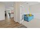 Cozy room with a blue sofa, carpet flooring, and wainscoting, viewed from open concept living area at 5108 Creekside Park Ave, Orlando, FL 32811