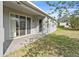 Covered patio with a brick floor and sliding glass door at 5108 Creekside Park Ave, Orlando, FL 32811