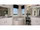 Bright bathroom features a soaking tub, dual vanities, and views from two large windows at 536 Moon Shell Cir, New Smyrna Beach, FL 32168