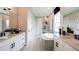 Bathroom featuring double sinks, soaking tub, a walk-in shower, and sleek fixtures at 536 Moon Shell Cir, New Smyrna Beach, FL 32168