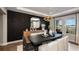 This formal dining room offers a stylish mirror, wooden buffet, and elegant black accent wall for sophisticated dining at 536 Moon Shell Cir, New Smyrna Beach, FL 32168
