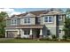 Inviting two-story home featuring a covered porch and a two-car garage at 536 Moon Shell Cir, New Smyrna Beach, FL 32168