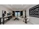 Spacious game room features a ping pong table, stylish decor, and comfortable seating for entertainment at 536 Moon Shell Cir, New Smyrna Beach, FL 32168