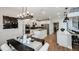 Modern eat-in kitchen boasts stainless appliances, white cabinetry, dark backsplash, and a dining area with modern light fixture at 536 Moon Shell Cir, New Smyrna Beach, FL 32168