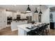 Modern kitchen with stainless steel appliances, sleek white cabinetry, and island seating at 536 Moon Shell Cir, New Smyrna Beach, FL 32168